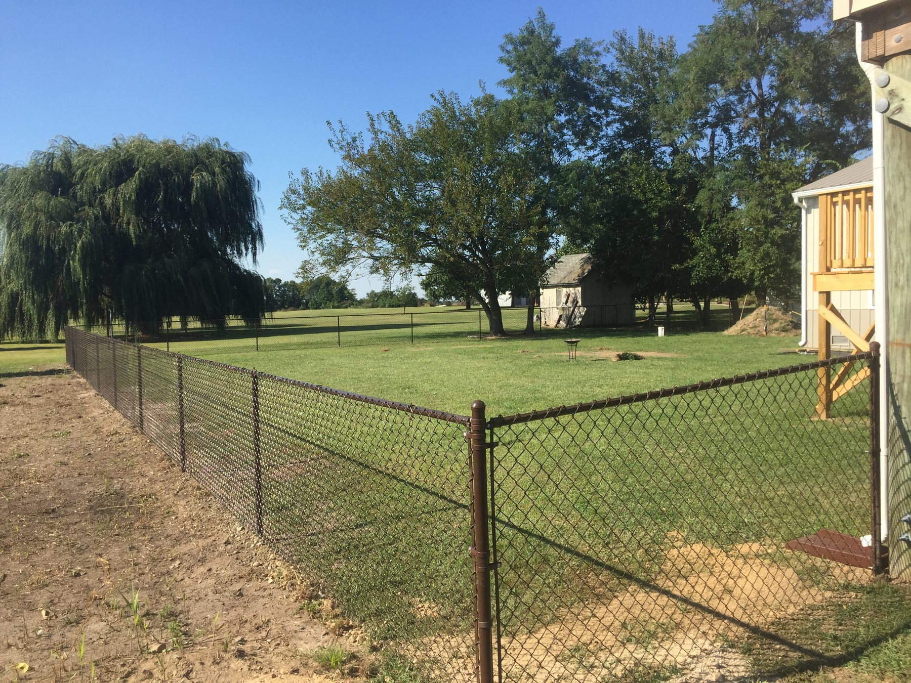 Galvanized chain link fence around a residential yard