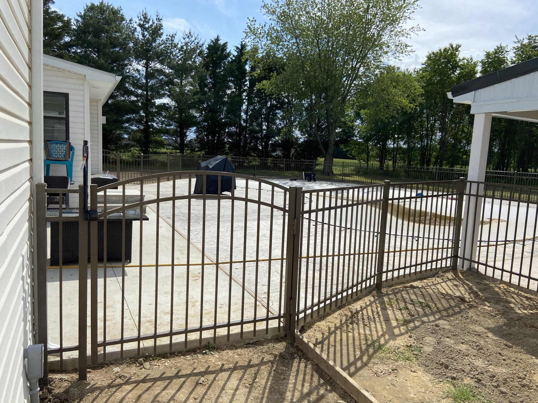 Black aluminum double gate with matching fence panels