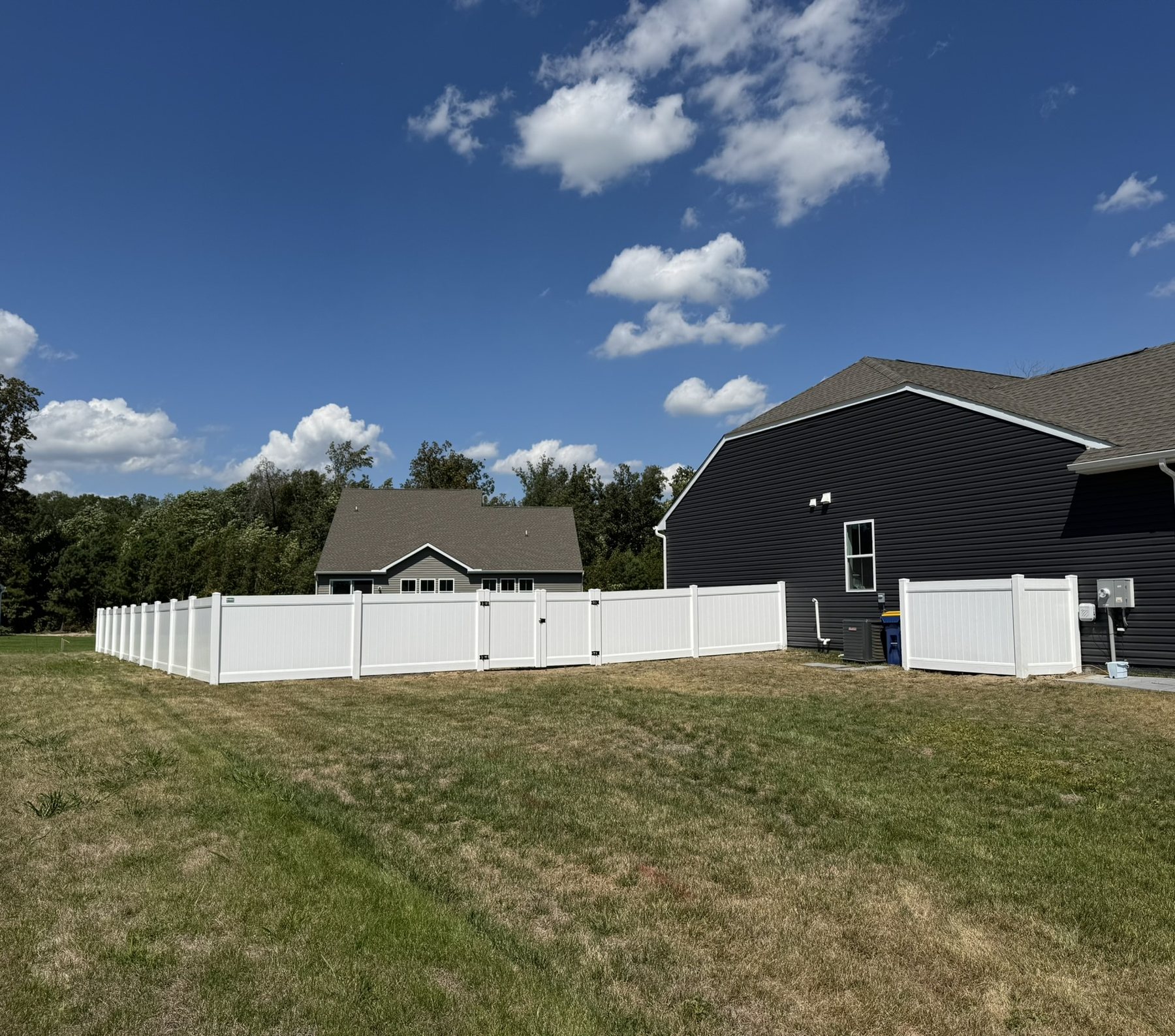 White vinyl privacy fence along a property line
