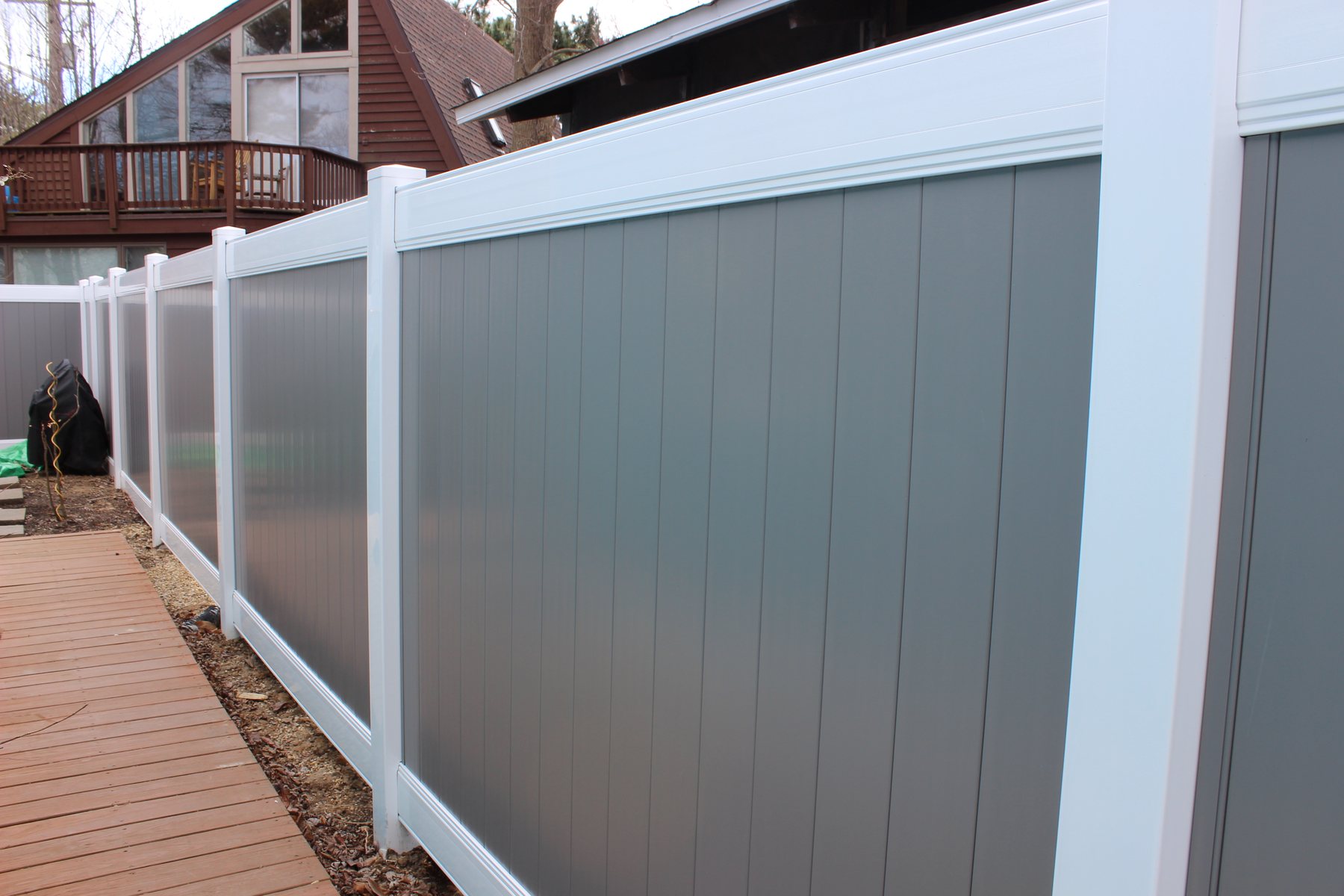 Two-tone white and gray vinyl privacy fence